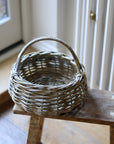 small round rattan basket with handle