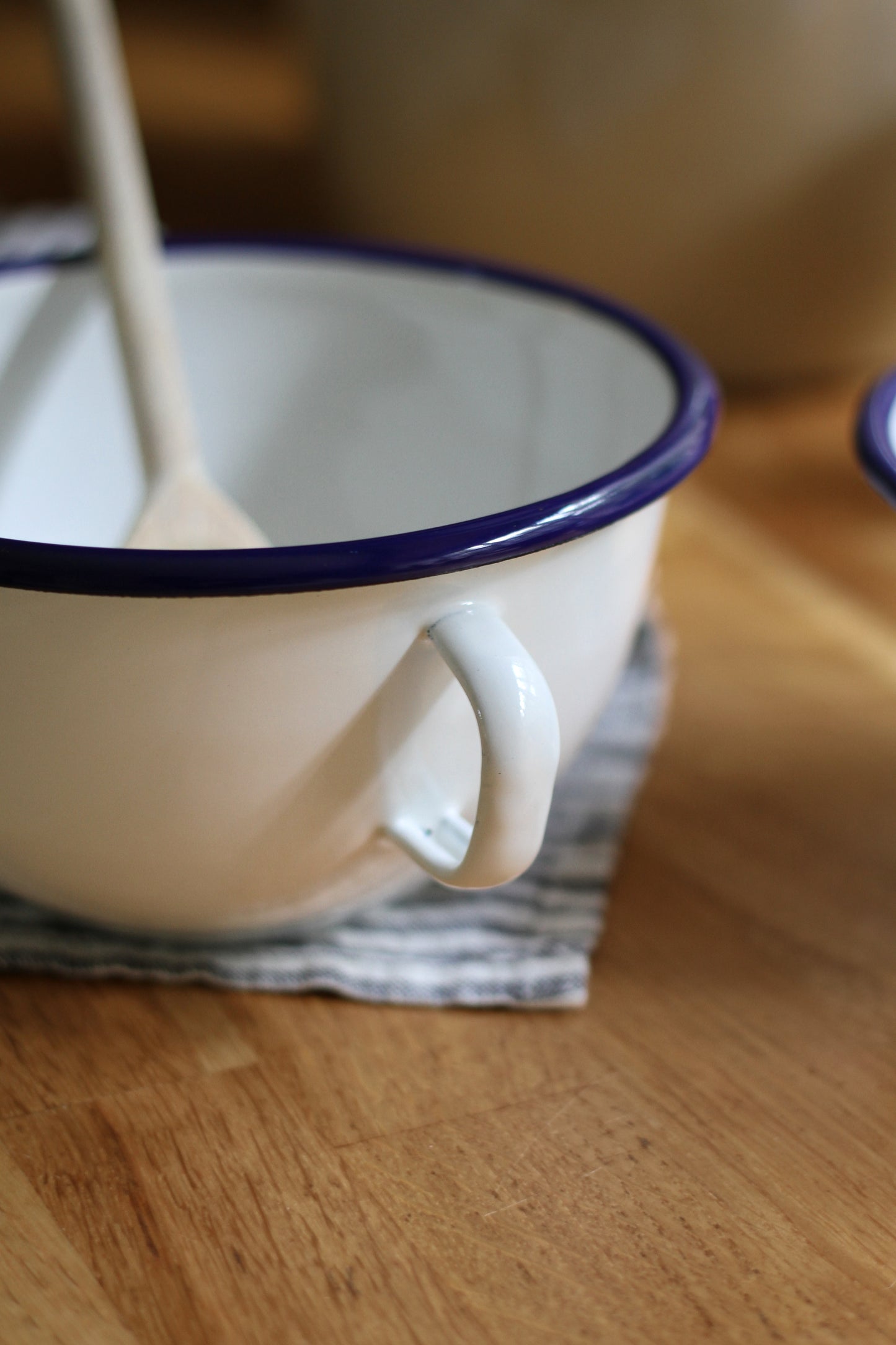 enamel bowl with handle and navy trim detail