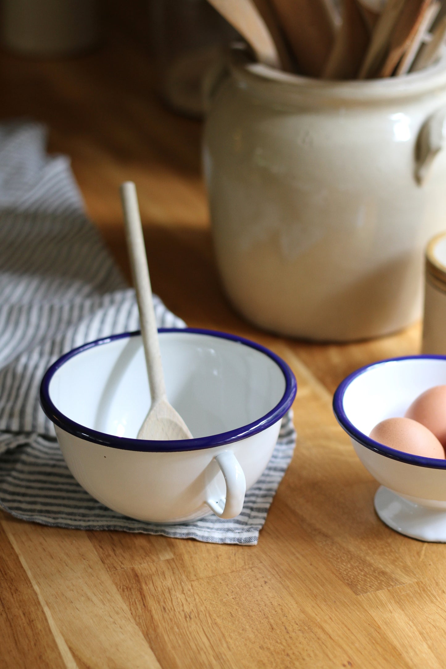 enamel bowl with handle and navy trim detail