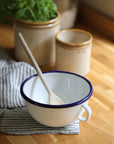 enamel bowl with handle and navy trim detail