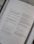 Open book with text on a neutral background