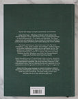 Back cover of a book with text on a marble surface