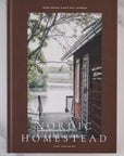 Book titled 'Nordic Homestead' with a cabin and lake scene on the cover.