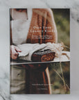 Book titled 'Once Upon a Country Kitchen' on a marble surface