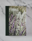 Book titled 'Living with Herbs' on a marble surface