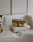 Bristle brush on a soap bar on a bathroom sink