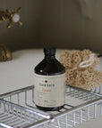 amber bath foam displayed on a roll top bath