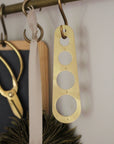 brass pasta measure hung on brass rail kitchen display