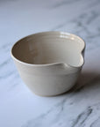 Beige ceramic bowl on a marble surface