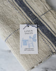 rustic beige linen table runner, with a blue stripe. French style.