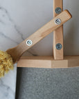 metal and wood dustpan and brush held together with magnets