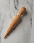 wooden seed dibber for making a hole in soil before planting a seed