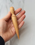 wooden seed dibber for making a hole in soil before planting a seed