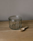 glass salt pot with lid and wooden spoon