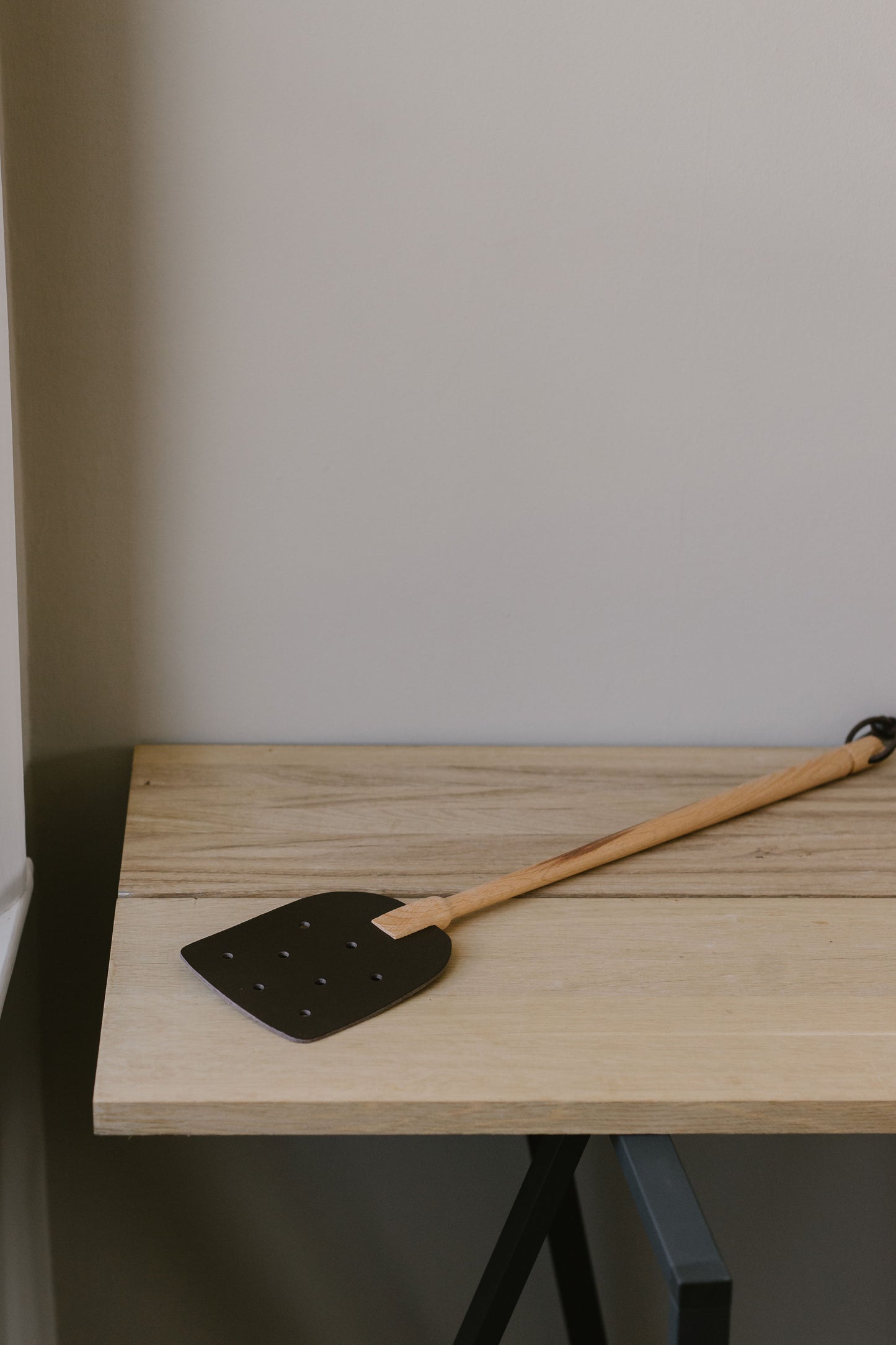 wooden and leather fly swat