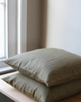 100% linen cushion with feather inner available in olive and natural