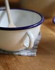 enamel bowl with handle and navy trim detail