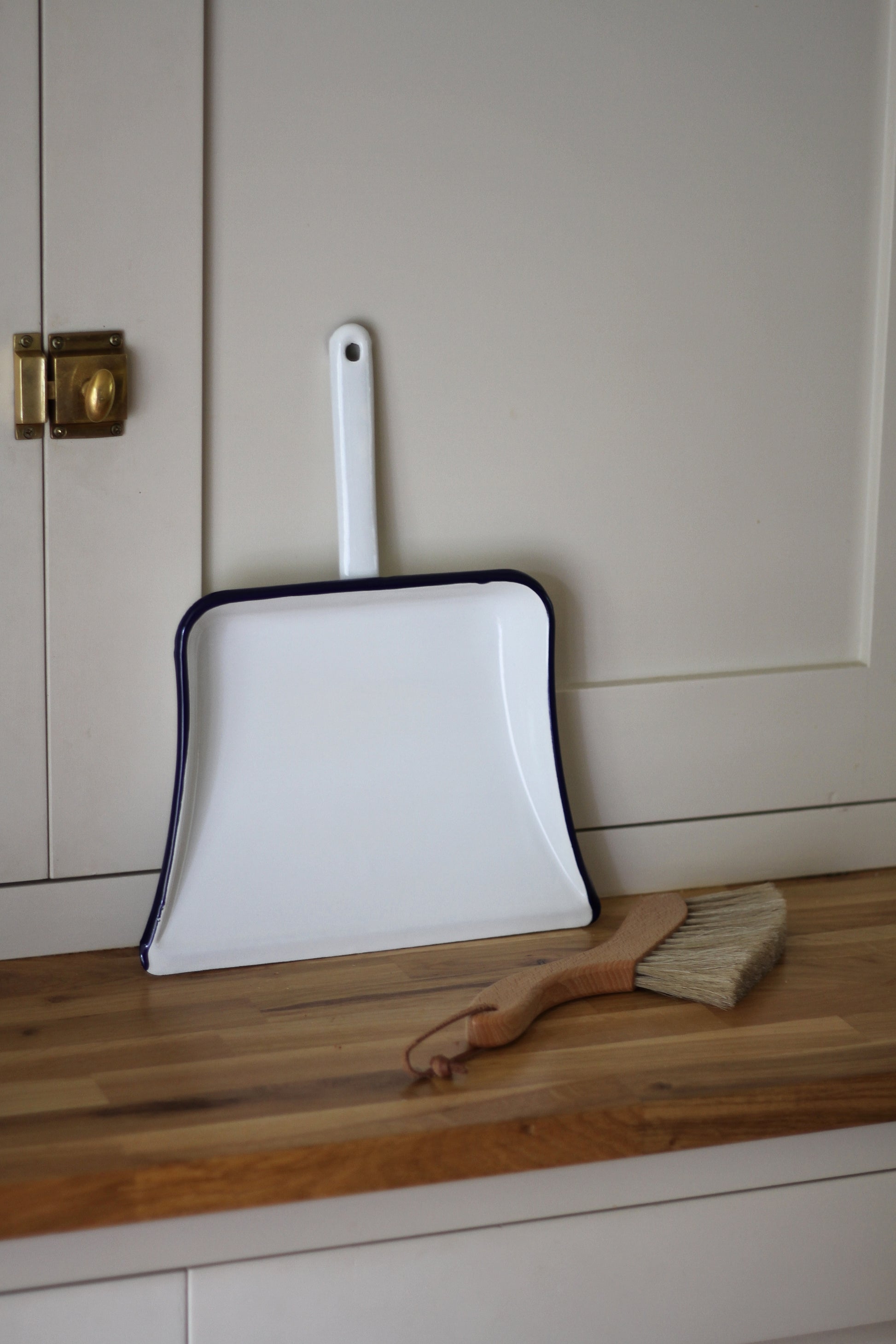 enamel dustpan with navy trim detail