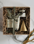 gift box with bath essence, hand cream, candle, brass bell