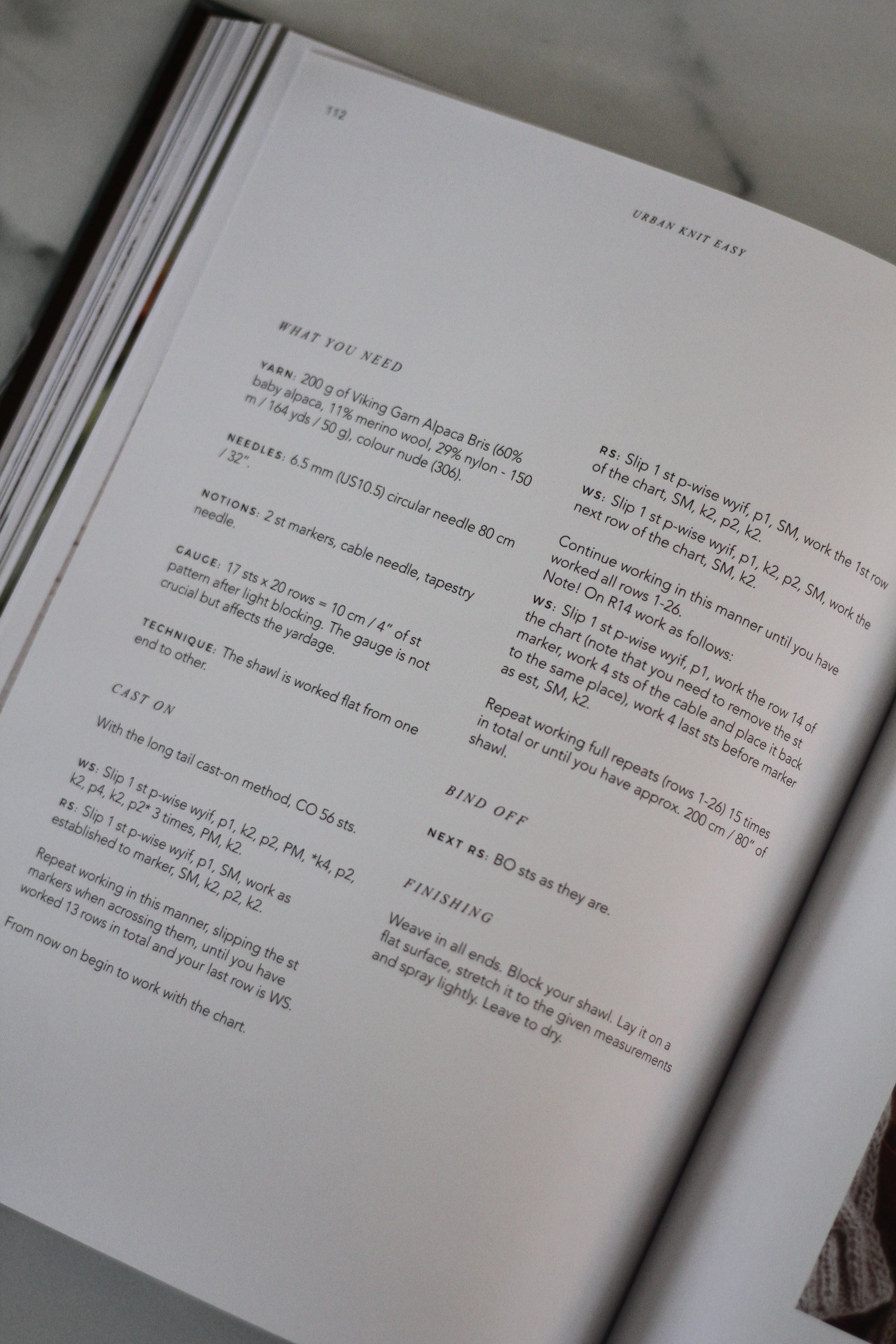 Open book with text on a neutral background