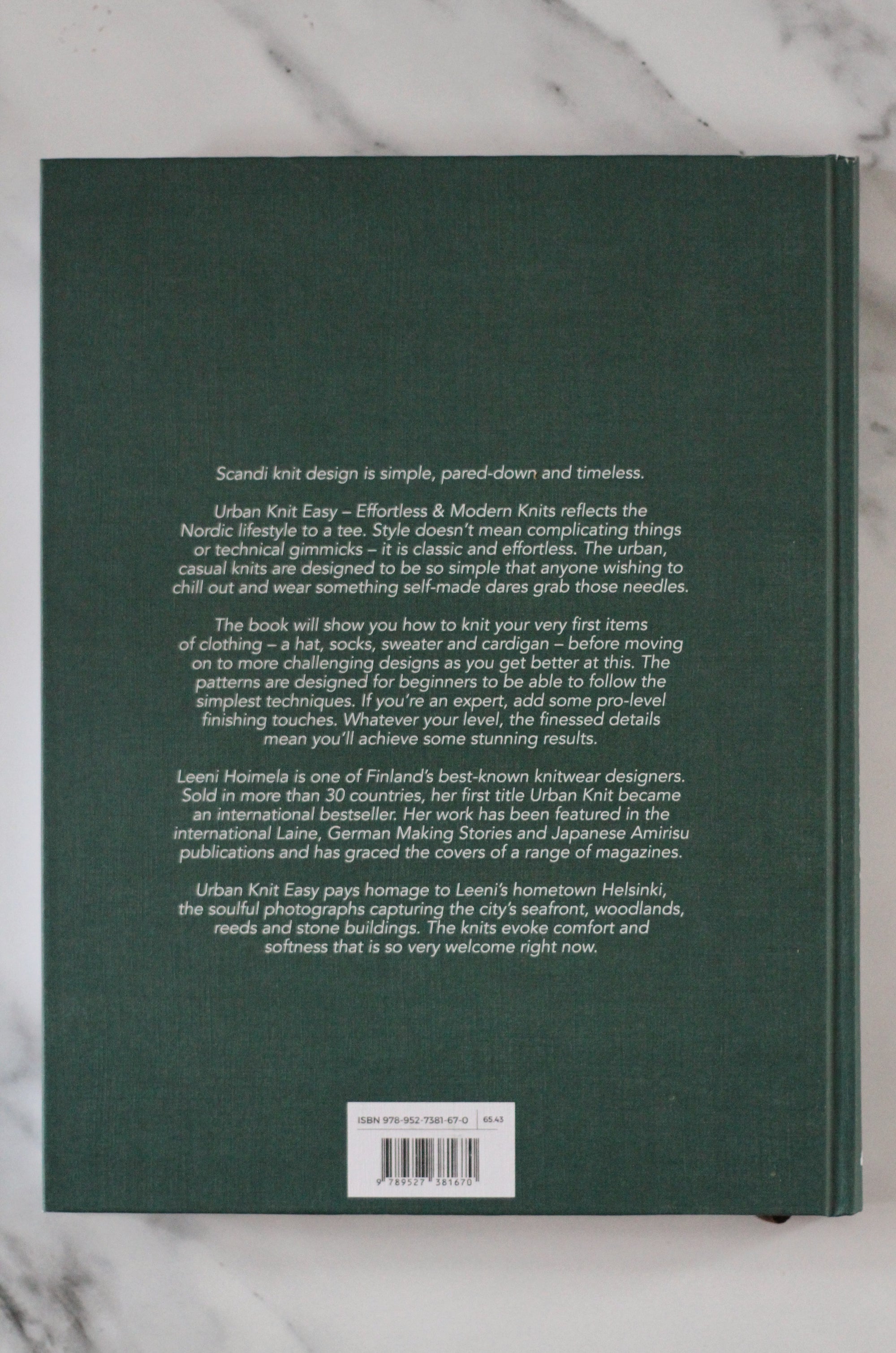 Back cover of a book with text on a marble surface