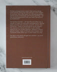 Brown book with text on a marble surface