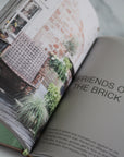 Open book with a page titled 'Friends of the Brick' and images of plants and architecture.
