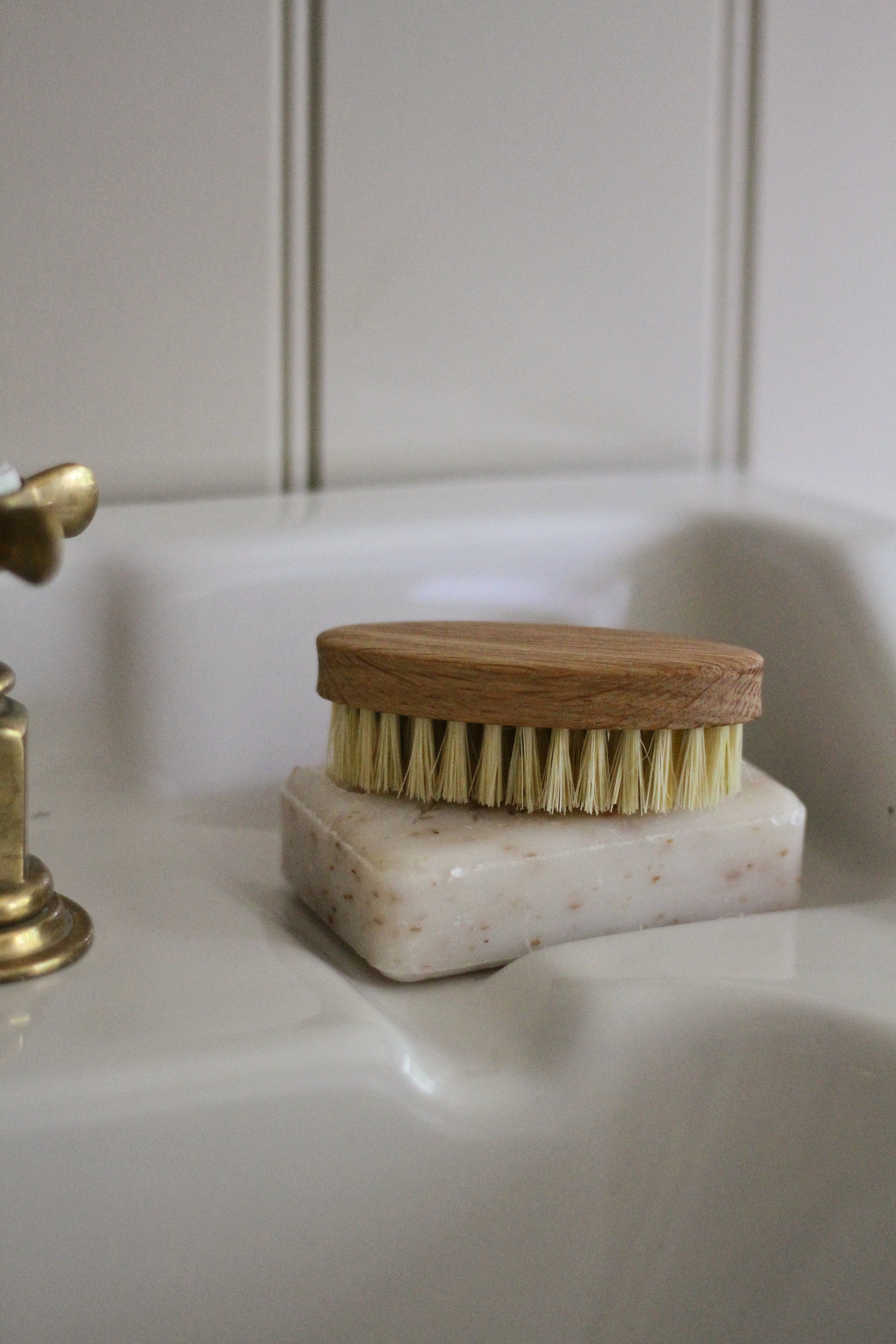 Bristle brush on a soap bar on a bathroom sink