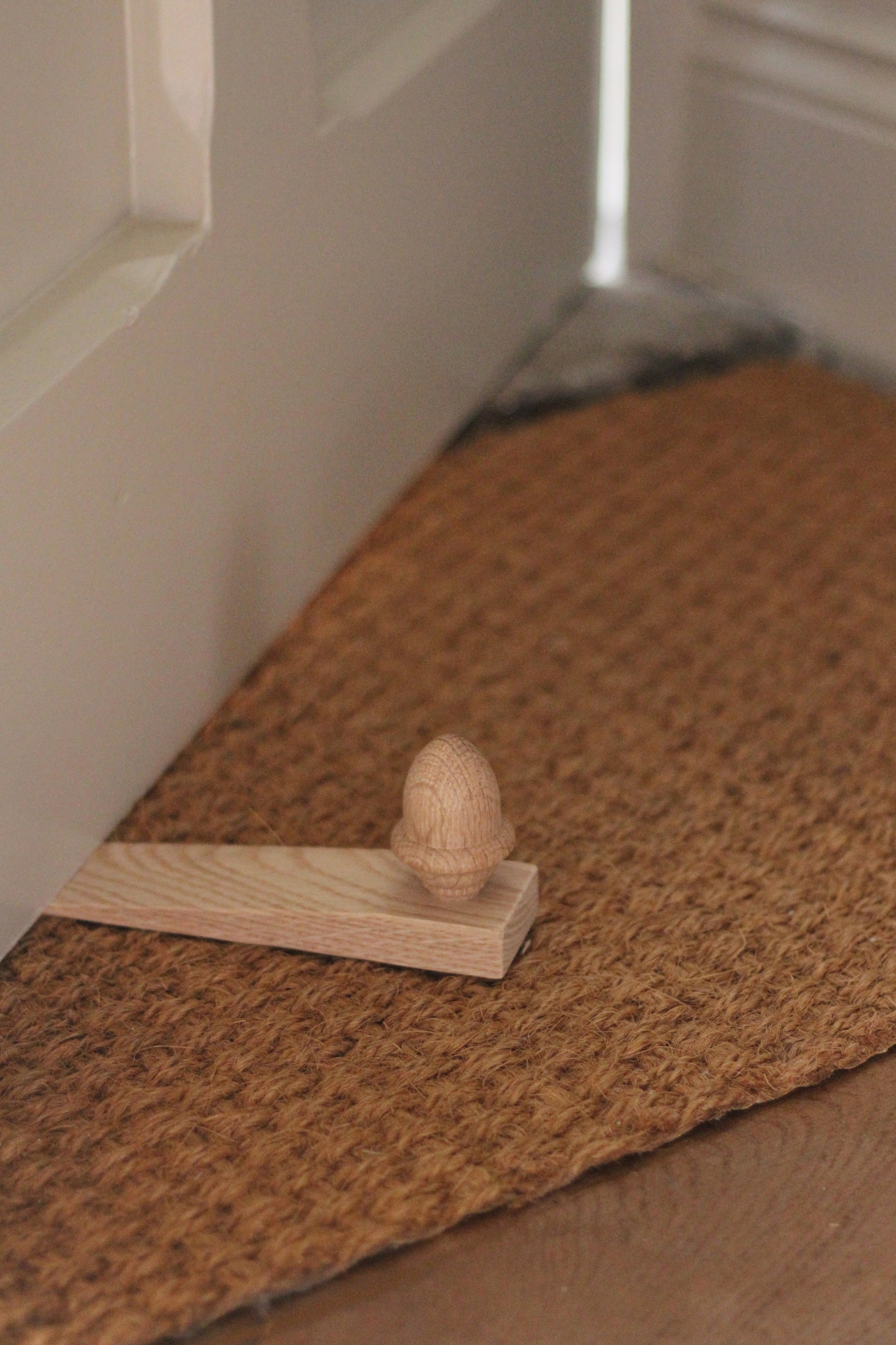oak door wedge with turned wooden acorn finial 
