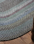 Braided jute rug in an oval shape in shades of green 