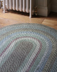 Braided jute rug in an oval shape in shades of green 