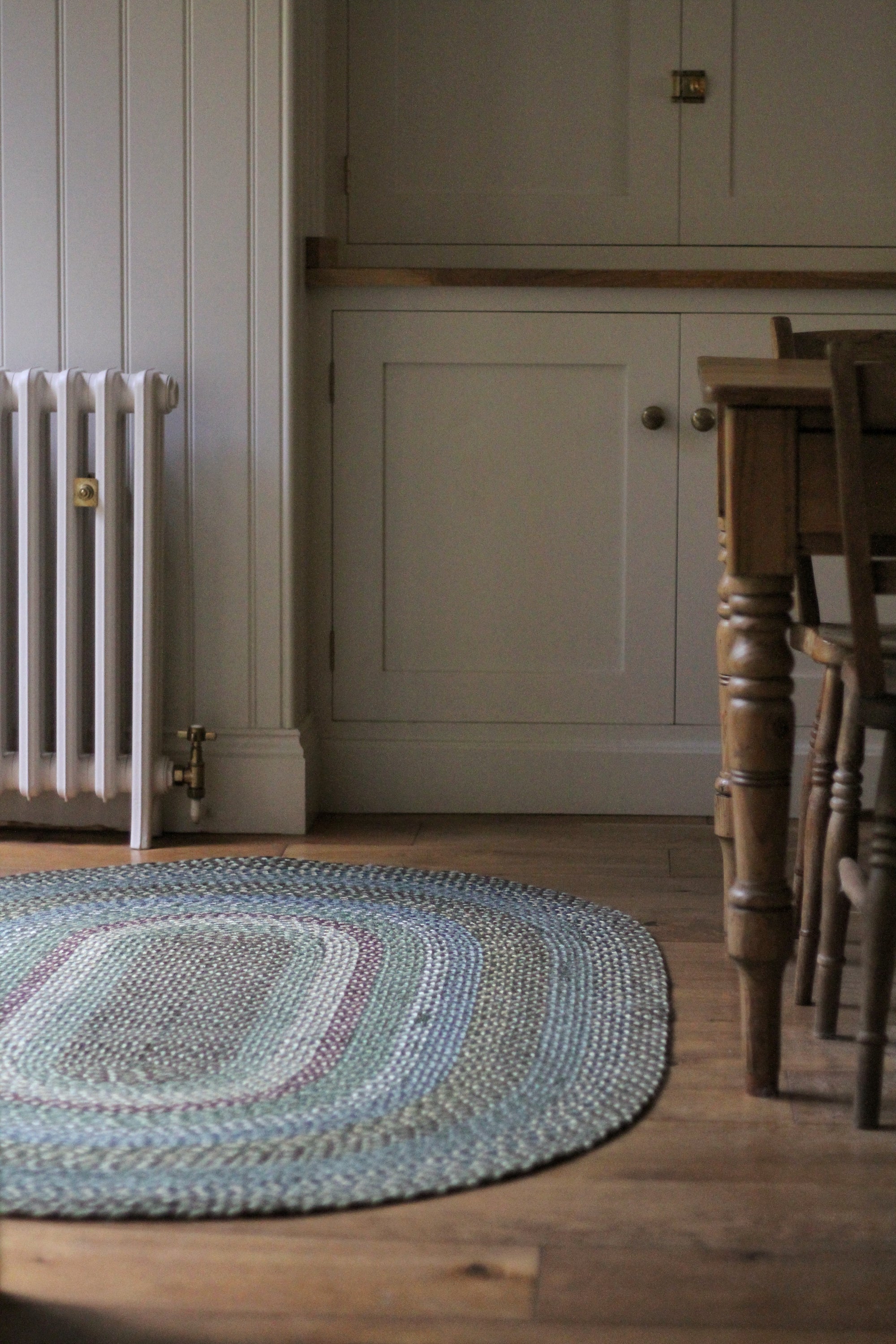 Braided jute rug in an oval shape in shades of green 