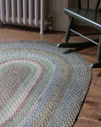 Braided jute rug in an oval shape in shades of green 