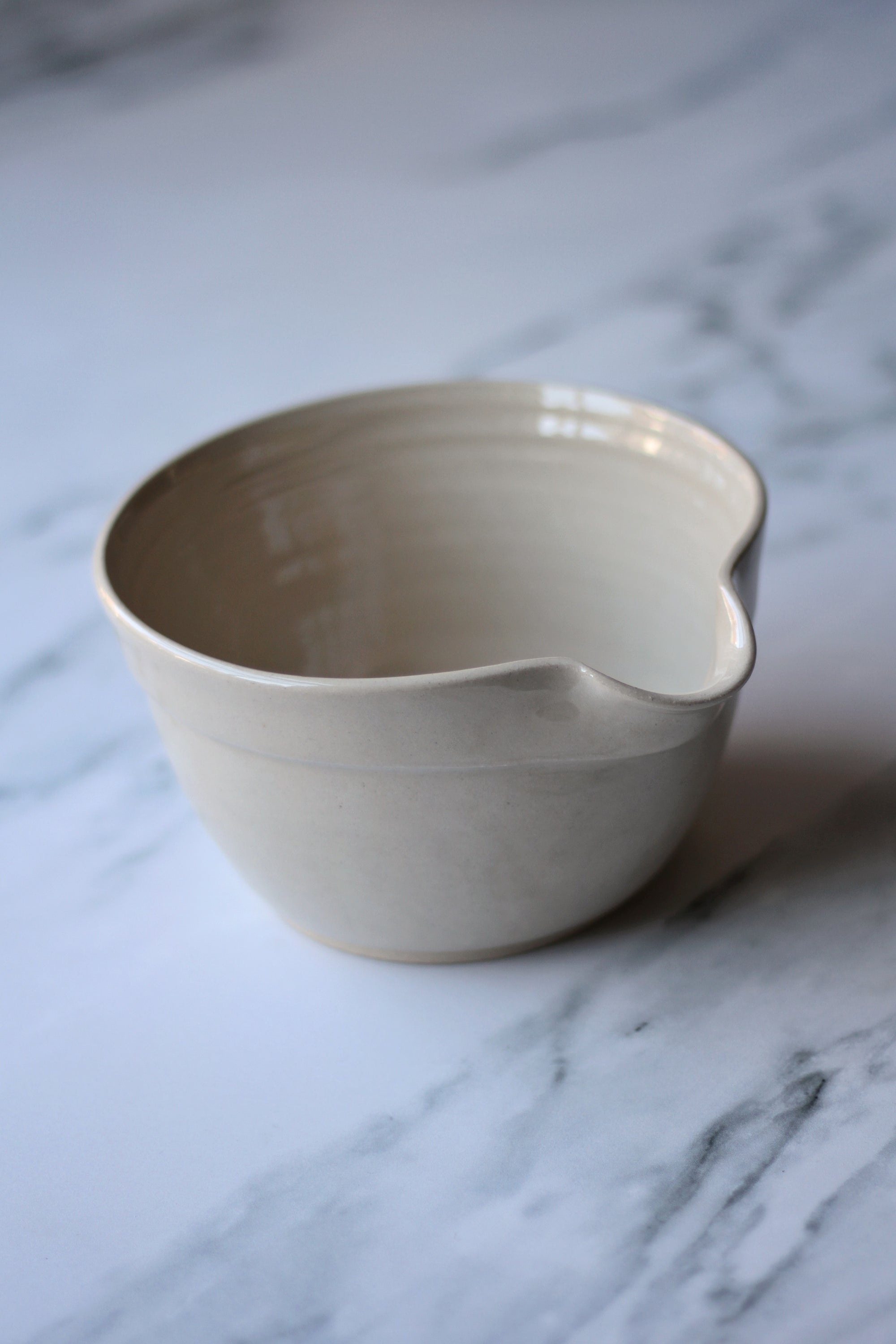 Beige ceramic bowl on a marble surface