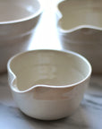Three ceramic bowls of different shapes on a light background