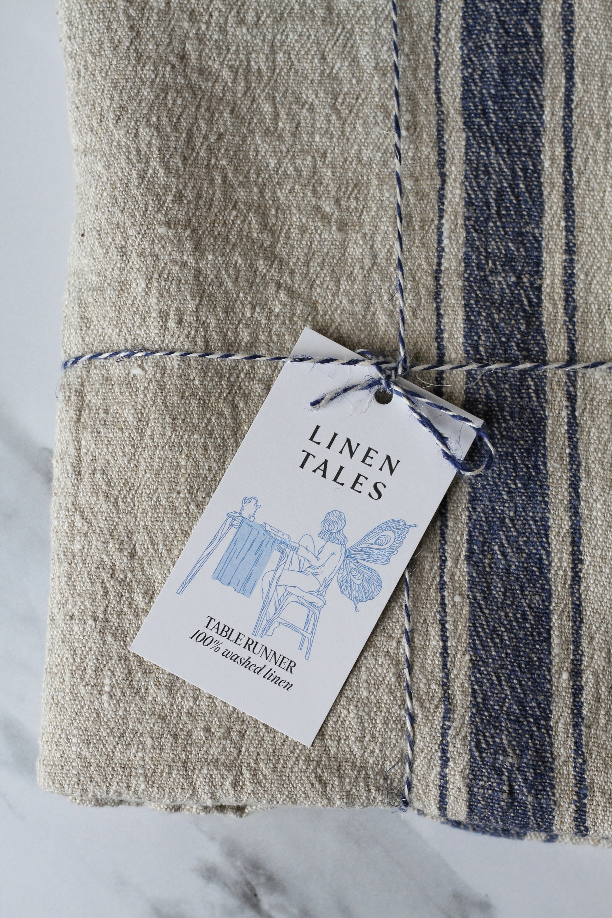 rustic beige linen table runner, with a blue stripe. French style.