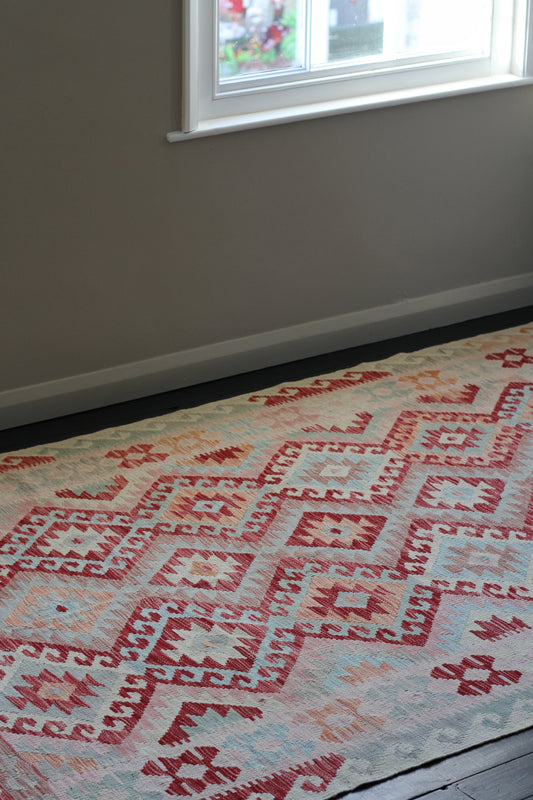 handmade persian kilim rug, colours pink, blue, orange.