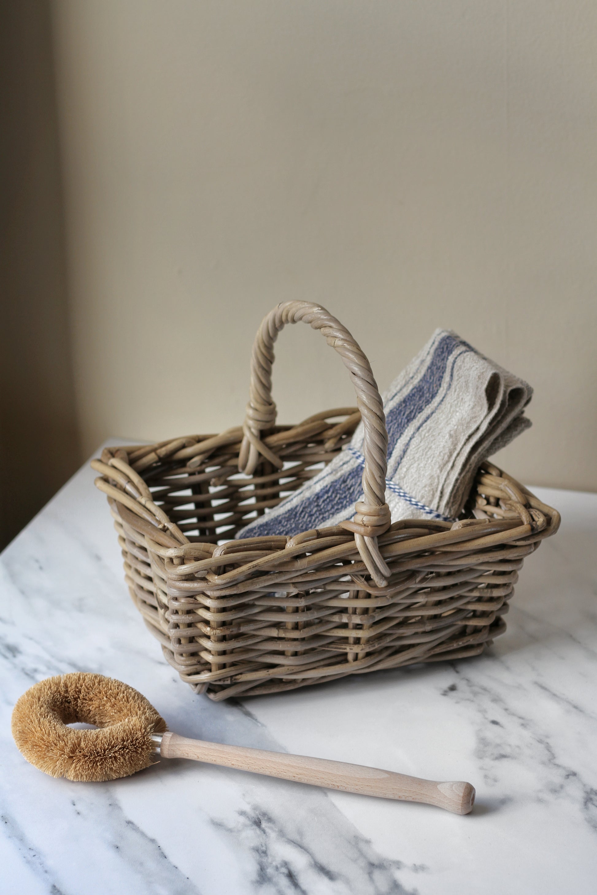 small grey wash rattan basket with handle