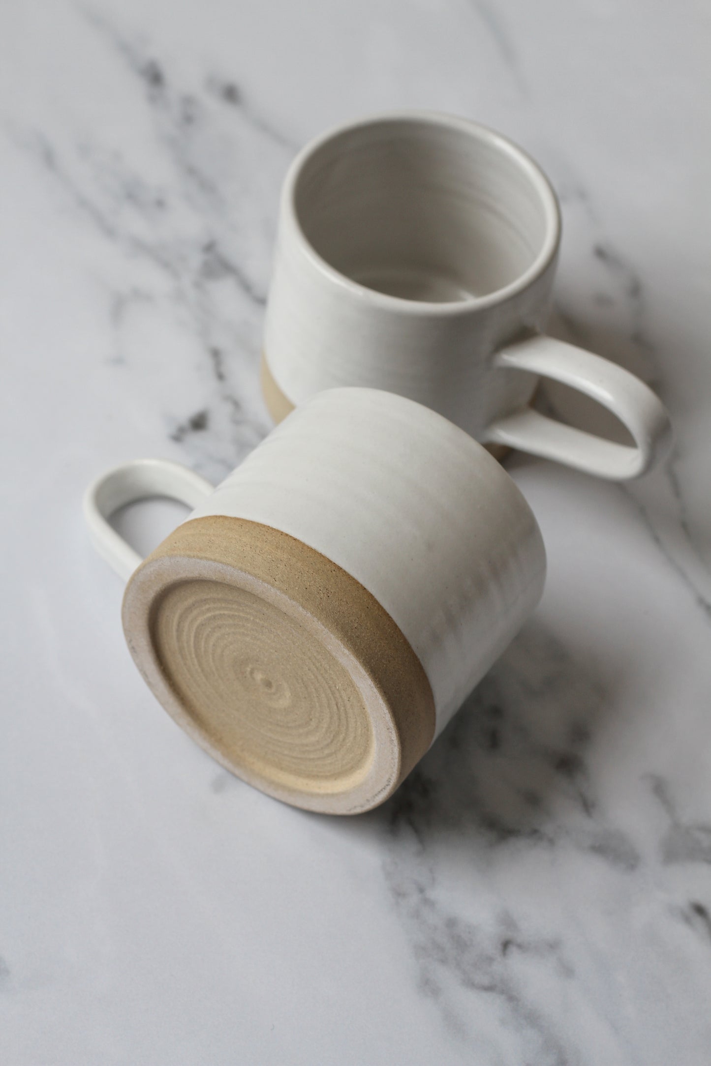 handmade stoneware mug with white glaze made in York, England by potter Philip Magson