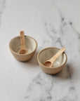pair of white pinch pots with wooden spoons