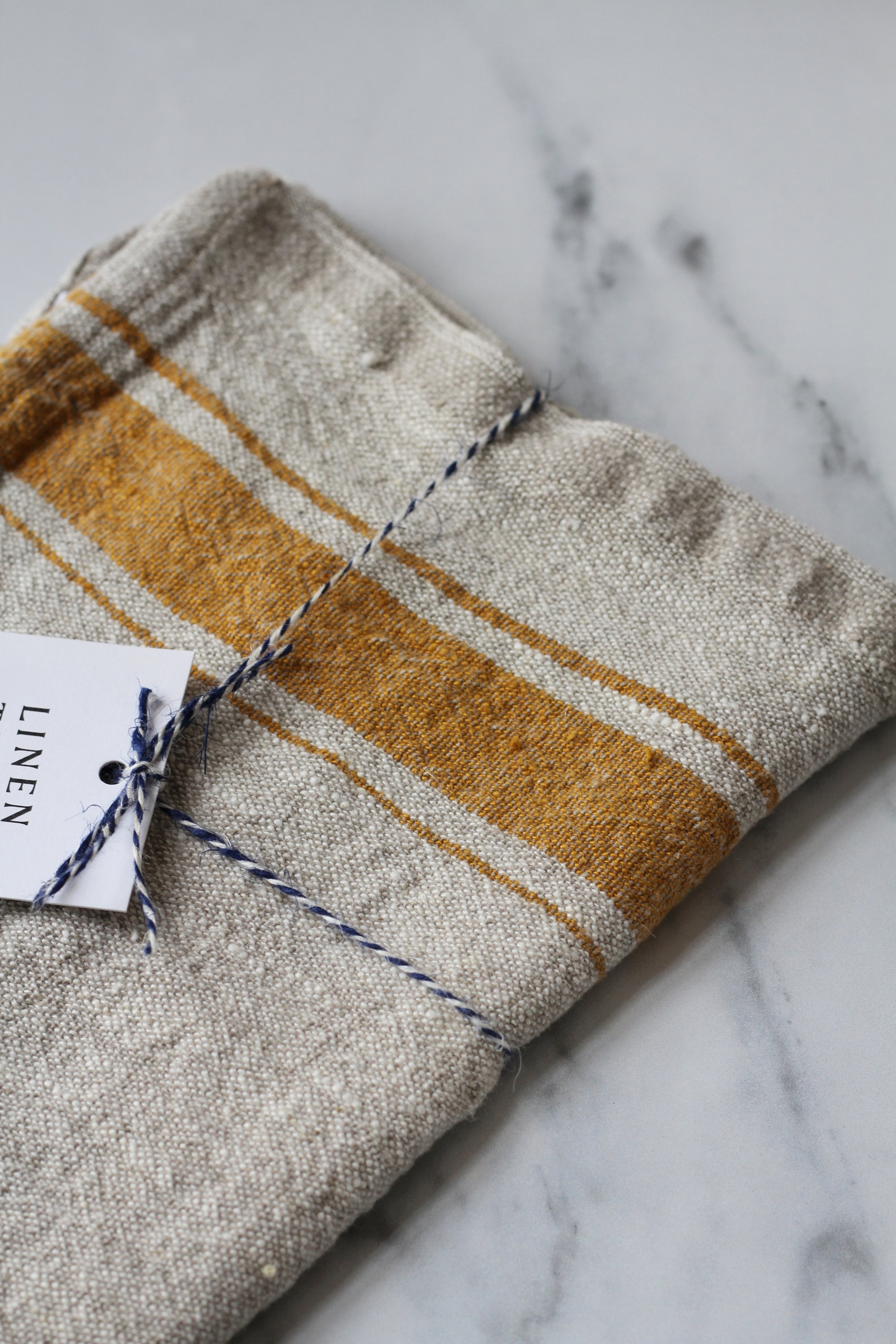 rustic linen tea towel natural linen colour with a mustard yellow stripe