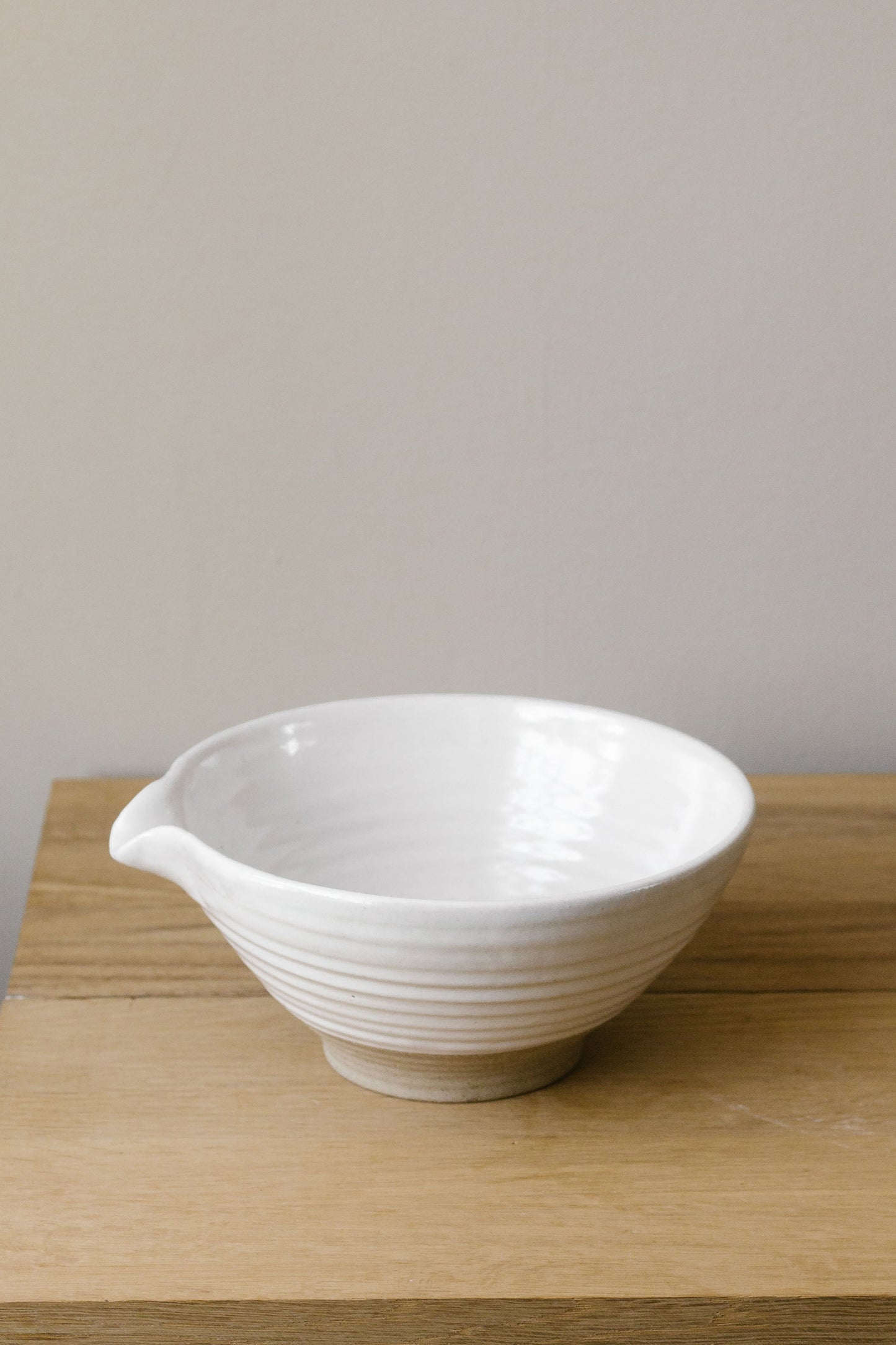 hand thrown pouring bowl in stoneware with a white glaze
