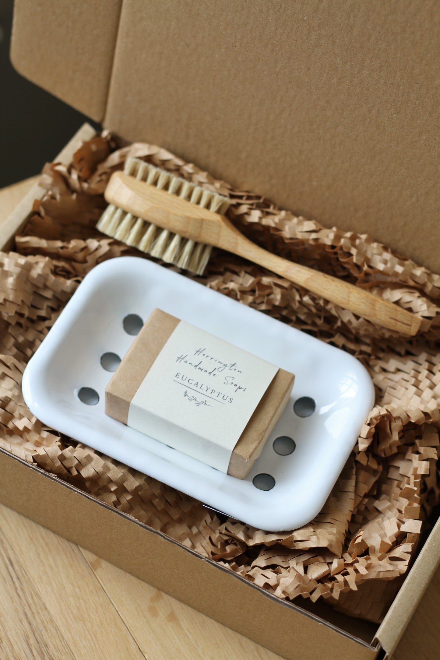 bathroom gift box includes enamel soap dish, handmade soap, wooden nail brush.