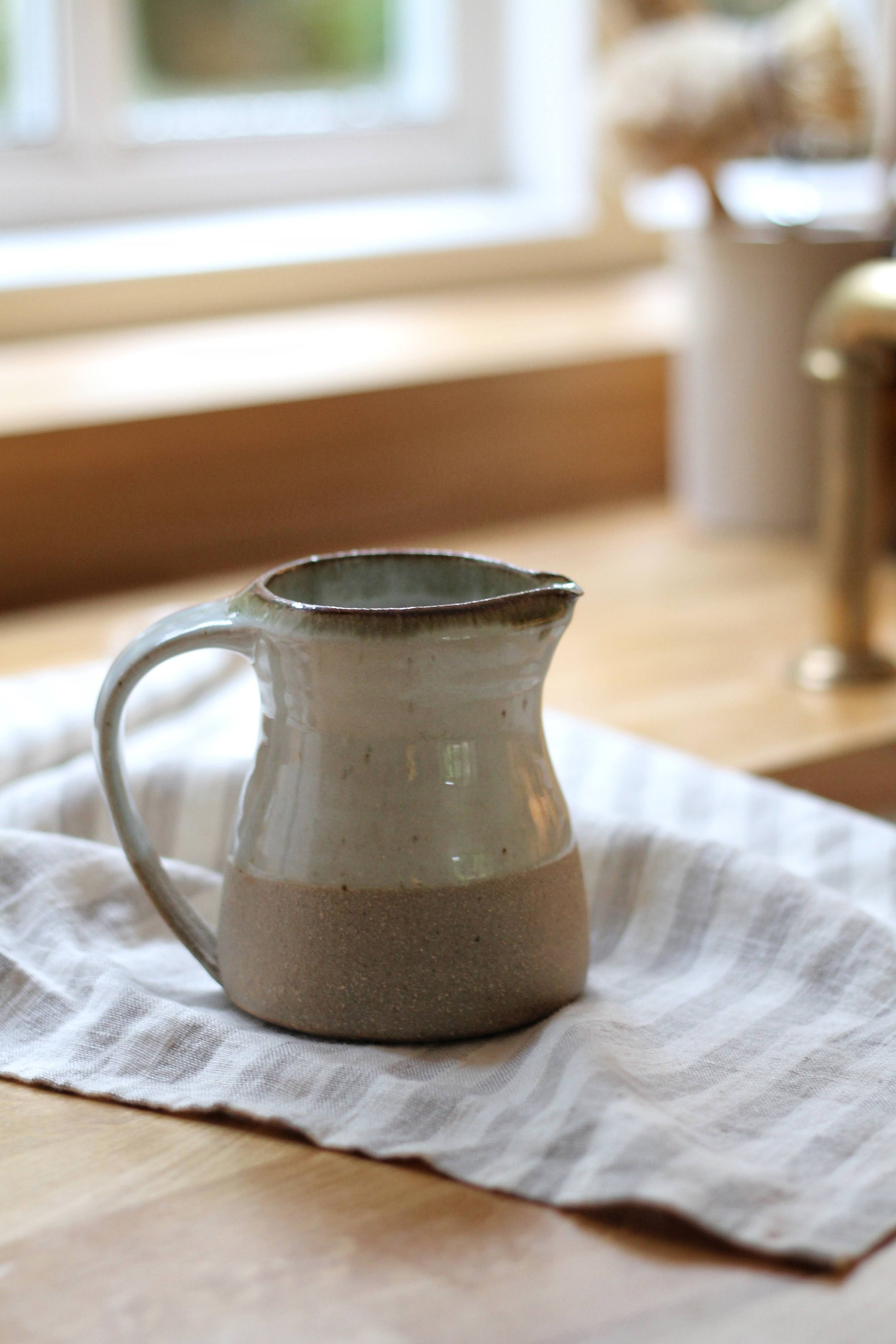 small leach pottery jug in dolomite glaze