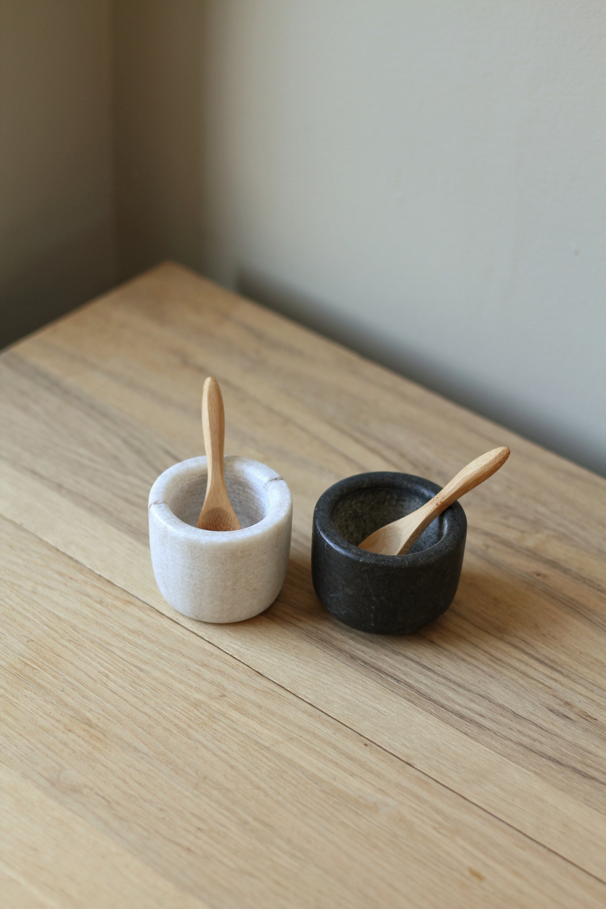 pair of marble salt and pepper pots with wooden spoons 